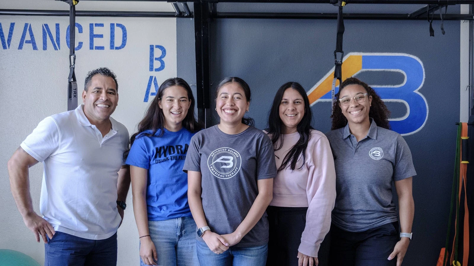 Dr. Gerard and four people photographed together inside Advanced Balance